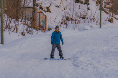 Full length of man on snow covered field