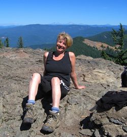 Portrait of young woman sitting on rock