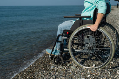 Woman in a wheelchair by the sea