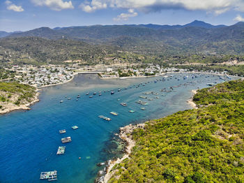 High angle view of boats on sea shore against sky