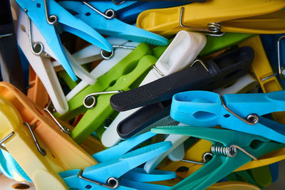 High angle view of multi colored clothespins on metal