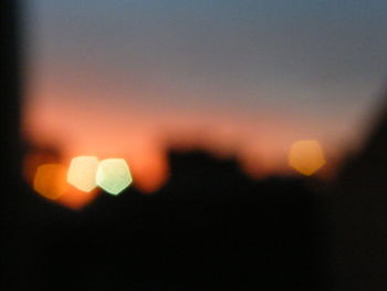 Close-up of illuminated lights at sunset