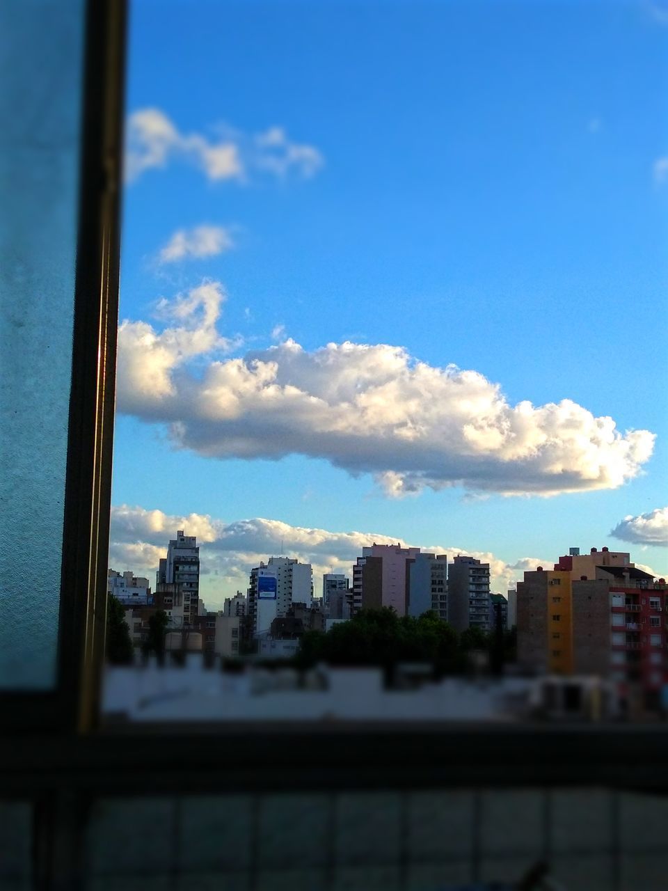 CITY BUILDINGS AGAINST BLUE SKY