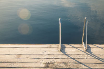 Railing on pier by river