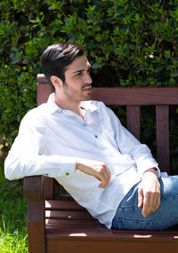 Young man sitting on bench