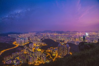 High angle view of illuminated buildings against sky at night