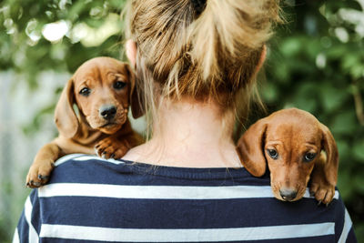 Woman with puppys standing outdoors