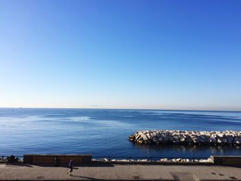 Scenic view of sea against clear blue sky