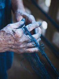 Close-up of human hand holding net