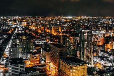 Aerial view of city lit up at night