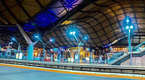 Illuminated railroad station in city at night