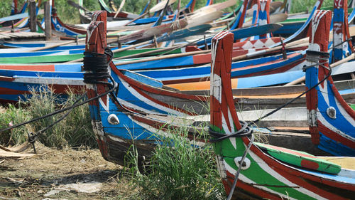 Multi colored boats moored on beach