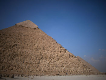 Scenic view of desert against clear blue sky