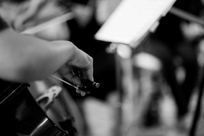 Close-up of person playing cello in orchestra