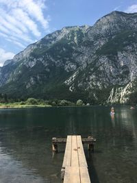 Pier in lake with mountain in background