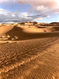 Sand dune in desert against sky