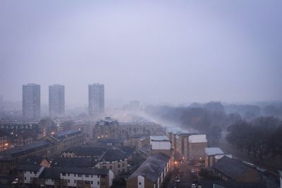 High angle view of illuminated cityscape against sky