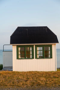 House on field against clear sky