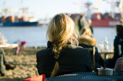 Rear view of woman sitting on chair