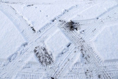 Close up view tire tracks at the surface of fresh fallen snow