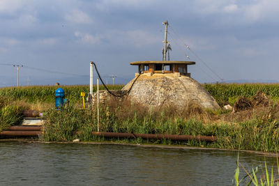 Built structure in water against sky