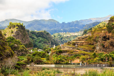 Scenic view of river and mountains against sky