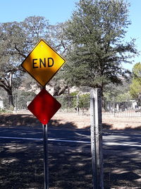 Road sign against trees