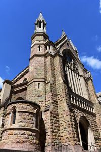 Low angle view of bell tower against sky