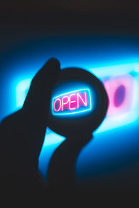 Close-up of hand on illuminated telephone