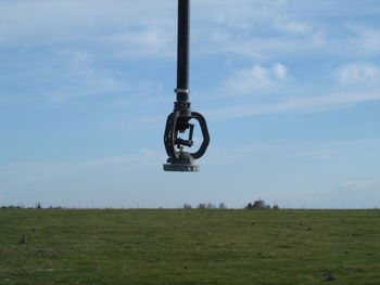 Bicycle on field against sky