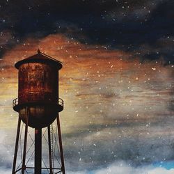 Low angle view of water tower against sky at night