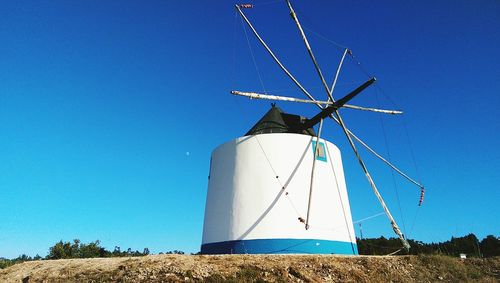 Traditional windmill against clear sky during sunny day