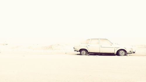 Bicycle parked in desert against clear sky