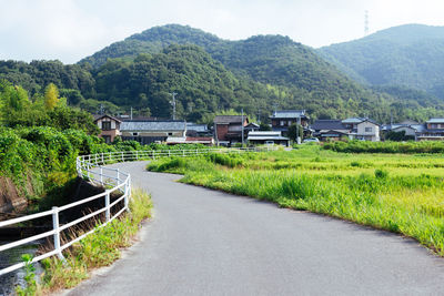 Road by mountain against sky
