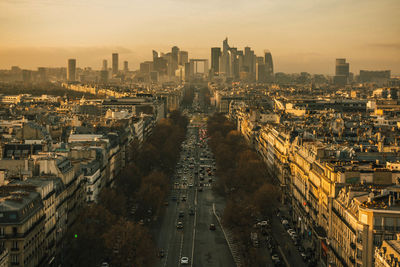 High angle view of city street amidst buildings against sky