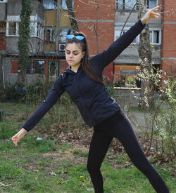 Full length of young woman standing on field