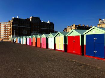 Beach huts against buildings in city