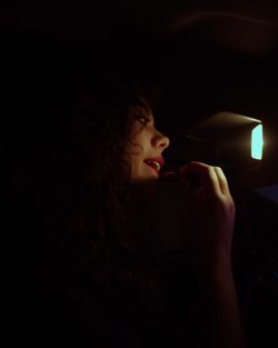 Young woman using mobile phone at night