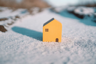 Close-up of toy model house on snow