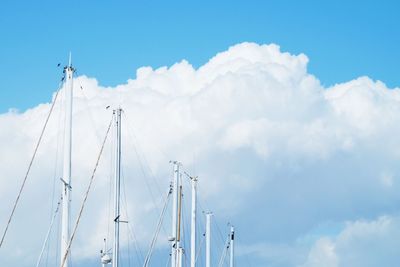 Low angle view of mast against blue sky