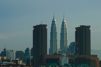 Petronas towers against sky in city