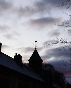 Low angle view of building against cloudy sky