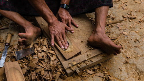 Low section of carpenter working in workshop