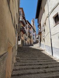 Low angle view of narrow alley amidst buildings in town