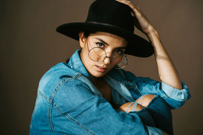 Portrait of young woman wearing hat