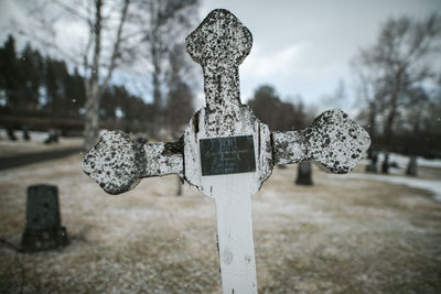 Close-up of cross on cemetery