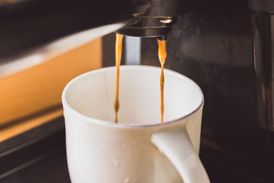 Close-up of coffee cup in glass