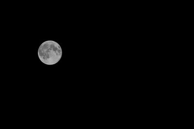 Low angle view of moon against clear sky at night