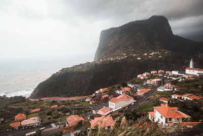 Scenic view of townscpe against mountain and sky