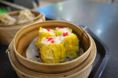 High angle view of dim sum in wooden bowl